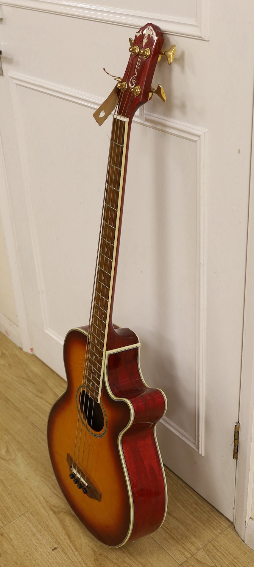 A Crafter electro-acoustic bass guitar. Model No. BA-600EQ/AMS-P Serial No. 00202718, 113cms high.